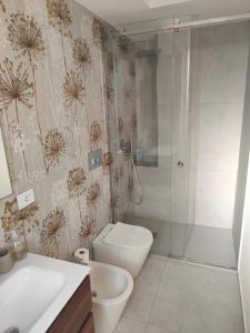 a bathroom with a shower and a toilet and a sink at AnnAmuri in Belpasso