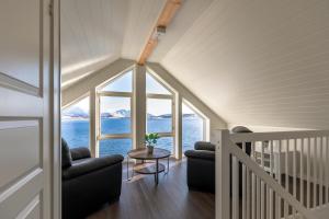a living room with a view of the water at Lofoten Rorbu Lodge in Offersøya