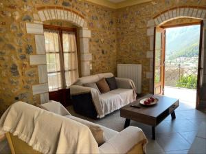 a living room with a couch and a table at Panorama Stonehouse in Leonidio +19 photos
