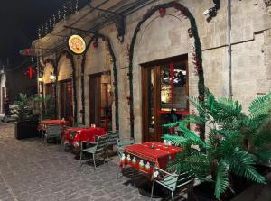a restaurant with tables and chairs in front of a building at LoCanda - Blat in Zahlé +6 photos