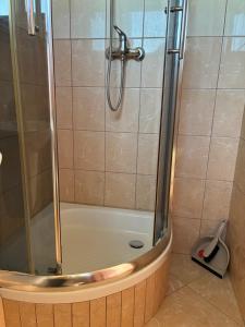 a shower with a glass door in a bathroom at Żółta Chata in Władysławowo +110 photos