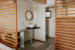 a bathroom with a sink and a mirror at Muchenje River Lodge in Katima Mulilo +99 photos