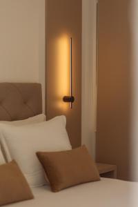 a bedroom with a bed and a lamp on the wall at Vujicic Premium Suite in Tivat