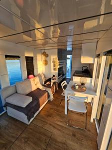 a living room with a couch and a table at Houseboat Bella in Tereszewo