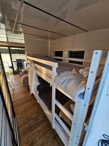 a bedroom with two bunk beds in a boat at Houseboat Bella in Tereszewo