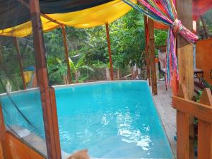 a swimming pool in a house with a canopy at Movement and Reposé in Clarks Town