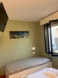 a bedroom with a bed with a view of the city at Affittacamere Cà Bianca in Casa Rossa +13 photos