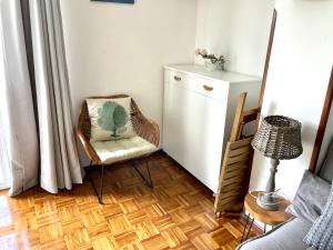 a room with a chair and a cabinet and a table at Rincon en el Rio Sella in Ribadesella