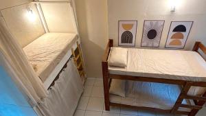 a small bedroom with two bunk beds in it at Pipa Surf House in Pipa +24 photos
