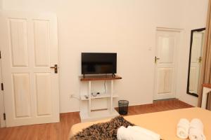 a living room with a tv on a white wall at Mino Villa Kandy in Kandy