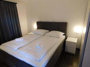 a bed with two white towels on top of it at Del Mar 2 in Kampor +38 photos