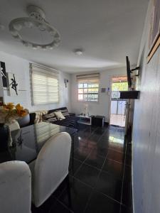 a living room with a couch and a table at Departamento en San Juan Capital 3 dormitorios hasta 6 personas in San Juan