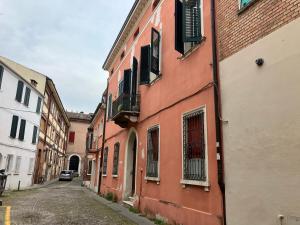 an alley in an old town with red buildings at Fondobanchetto in Ferrara