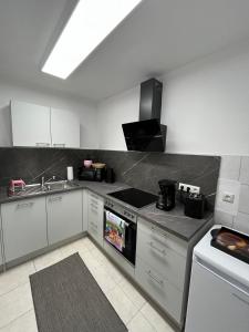 a kitchen with a sink and a stove top oven at Ferienwohnung Tor zum Oberwald in Herbstein