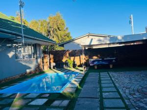 a swimming pool in the yard of a house at Ojong's Self Catering Accommodation Bellville in Cape Town