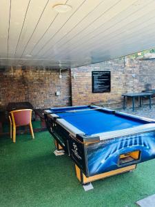 a pool table in a room with a table and a chair at Ojong's Self Catering Accommodation Bellville in Cape Town