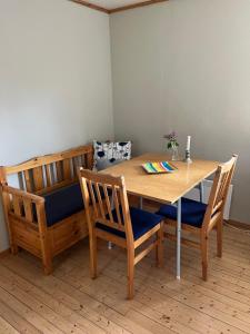 a dining room table with two chairs and a wooden table at 2 bedroom apartment with beautiful view in Sauda