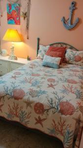 a bedroom with a bed with a fish themed bedspread at 210 Worcester St #203 OC in Ocean City