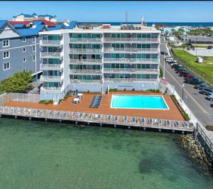 an apartment building with a swimming pool next to the water at 210 Worcester St #203 OC in Ocean City