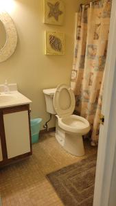 a bathroom with a toilet and a sink at 210 Worcester St #203 OC in Ocean City +27 photos