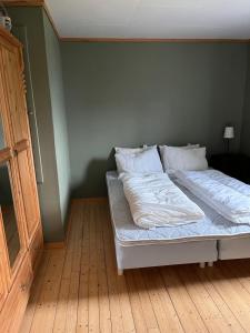 a bed in a room with a wooden floor at 2 bedroom apartment with beautiful view in Sauda