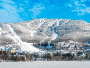 a snow covered mountain with a ski slope at Fairmont Tremblant in Mont-Tremblant
