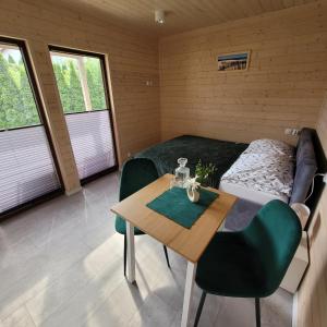 a room with a bed and a table and a bed and a bedroom at Gdansk Stogi Beach in Gdańsk