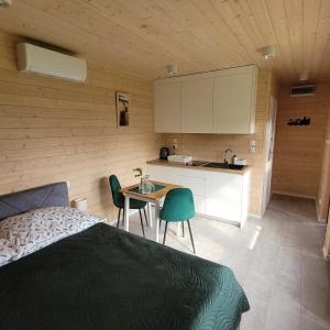 a bedroom with a bed and a table and a kitchen at Gdansk Stogi Beach in Gdańsk
