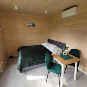 a bedroom with a bed and a table in it at Gdansk Stogi Beach in Gdańsk