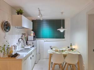 a kitchen with a table and chairs in a kitchen at 원하우스 in Seoul