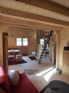ein Wohnzimmer mit einer Wendeltreppe in einem Blockhaus in der Unterkunft Ferienhaus Holzhaisl in Kelheim
