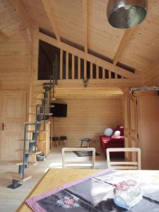 a living room with a red couch and a wooden ceiling at Ferienhaus Holzhaisl in Kelheim