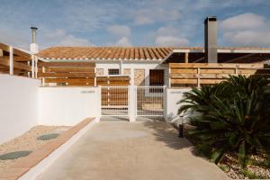 a house with a gate in front of it at Masia CHOPO in L'Aldea