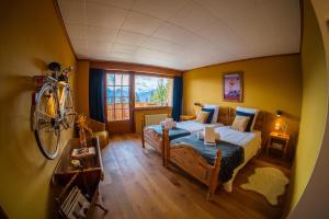 a bedroom with a bed and a bicycle on the wall at Colorado Riders Chalet in Crans-Montana