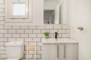 a white bathroom with a toilet and a sink at Tiny House La Loma in Barbate +15 photos