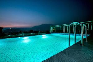 a swimming pool at night with lights on it at Beautiful Kathmandu Swimming pool Hotel in Kathmandu