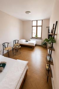 a living room with two beds and a couch at Hotel Gryf in Gryfice +26 photos