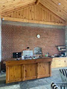 a brick wall with a wooden counter in a room at Devshal Eco-Stays in Gupta Kāshi +65 photos