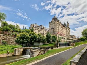 an empty road in front of a large building at Fairmont Chateau Laurier in Ottawa