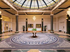 a lobby with a table and a glass ceiling at Fairmont Empress Hotel in Victoria +216 photos