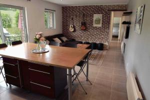 a kitchen and living room with a table and a couch at Gite Ô pré in Beaubec-la-Rosière +30 photos