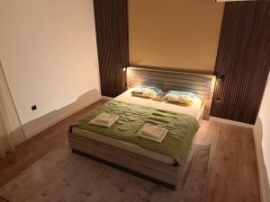 a bedroom with a bed with two towels on it at Casa nel verde in Bar