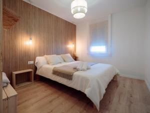 a bedroom with a large bed with white sheets and a window at Masia CHOPO in L'Aldea +96 photos