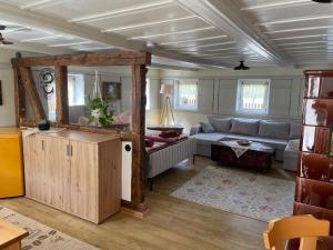 a living room with a couch and a table at FEWO Blockstube Frieda in Kottmar