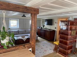 a living room with a couch and a kitchen at FEWO Blockstube Frieda in Kottmar