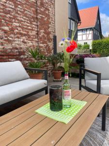 a bottle of wine on a table on a patio at FEWO Blockstube Frieda in Kottmar +10 photos