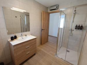 a bathroom with a sink and a shower at Casa Rural Las Alcusa in Cubla +13 photos