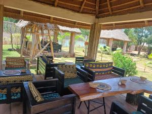 an outdoor patio with tables and chairs at Jedd Palace in Kpannou