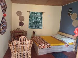 a small bedroom with a bed and a window at Jedd Palace in Kpannou +2 photos