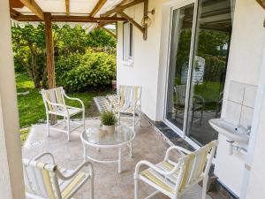 a patio with chairs and a table and a sink at Le JUJUBIER in Le Robert +5 photos